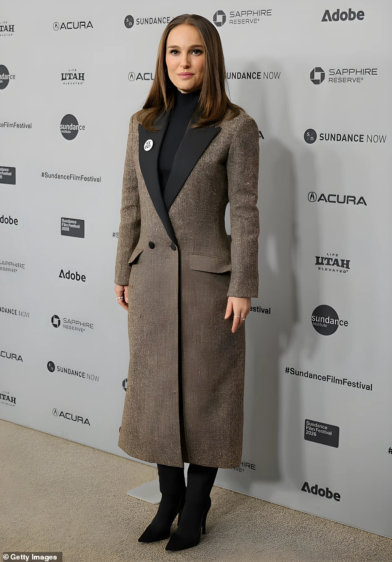 Portman seemed to be displaying a hint of a baby bump in her double-breasted coat