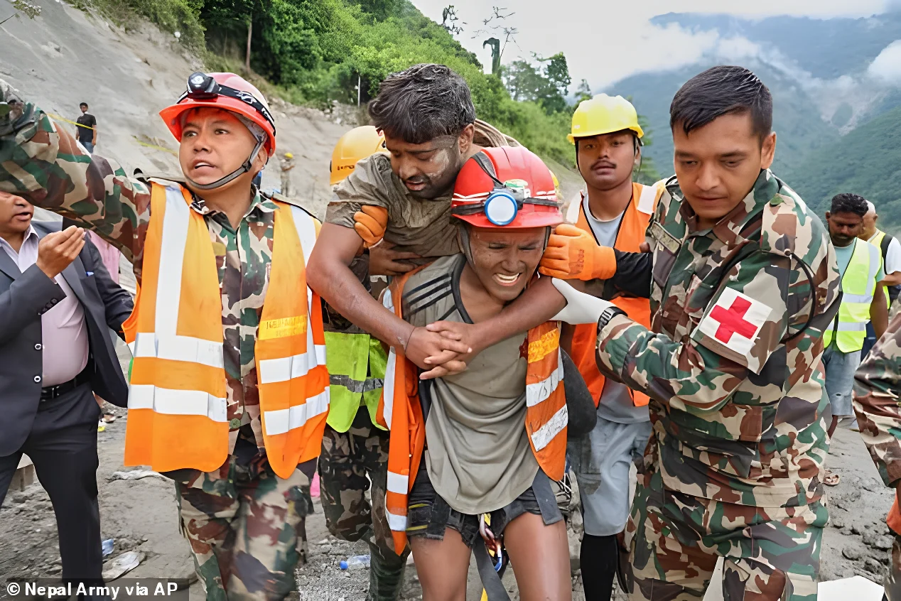 Rescue crews are seen carrying one of the freed power plant workers to safety