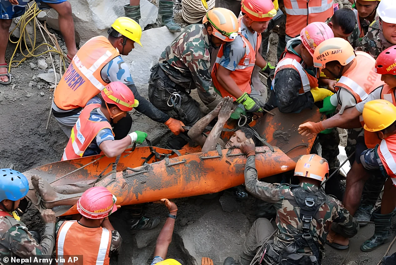 Soldiers are pictured carrying a powerplant worker to safety on Friday morning